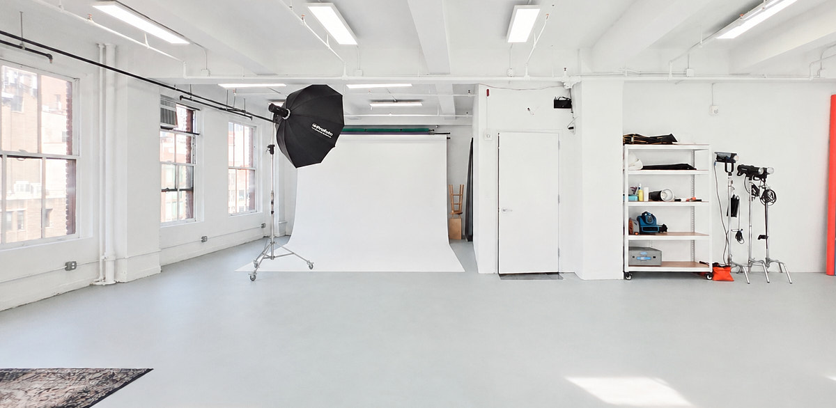 Studio production lighting and backdrop setup in a Garment District studio for a Fashion Week shoot or fitting