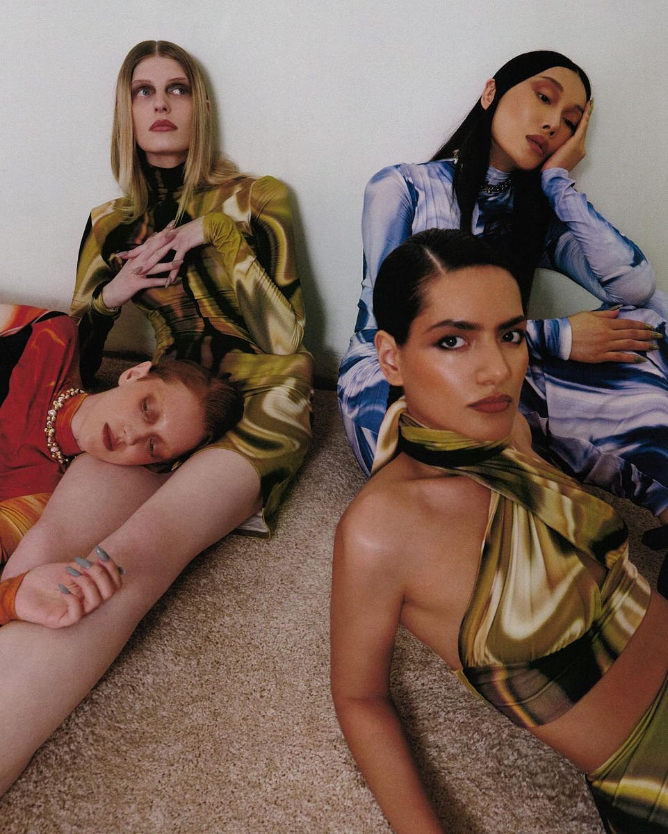 Group fashion campaign image with multiple models posed together in colorful styling
