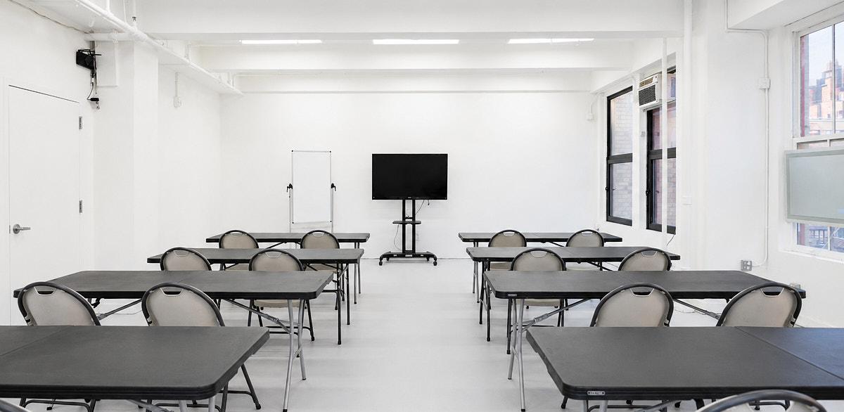 Classroom-style seating facing a presentation area in a Midtown Manhattan corporate event space near Penn Station