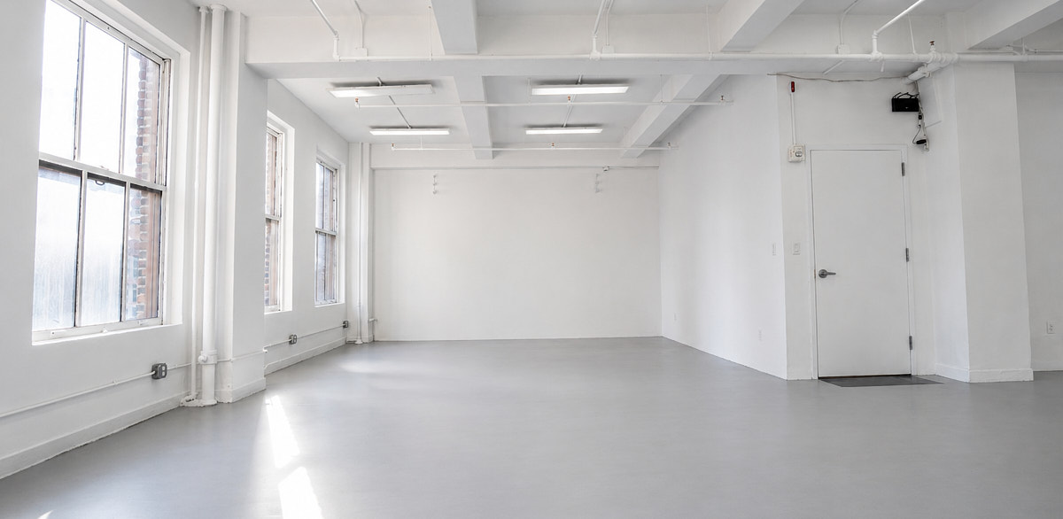 Empty white NYC production studio, representative of the photo studio listings analyzed in this price study