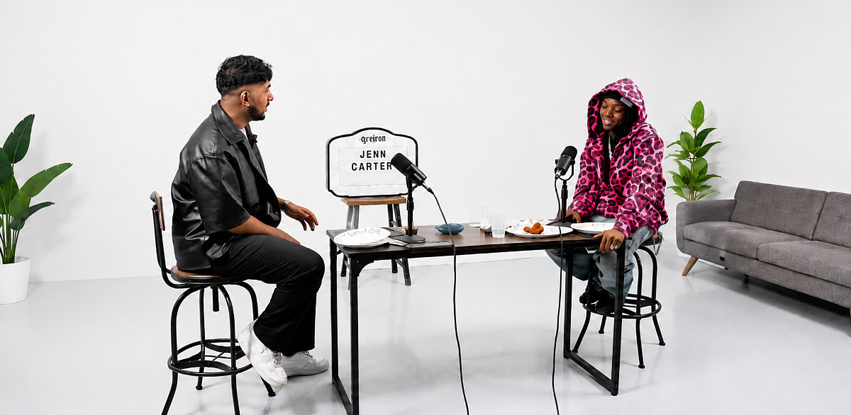 Two-person podcast interview setup in a clean white Midtown studio with seated guests and a minimal recording layout