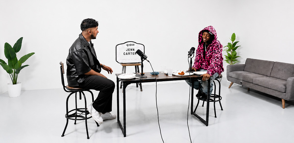Two-person interview setup in a clean white Midtown video studio with seated talent and a minimal production layout