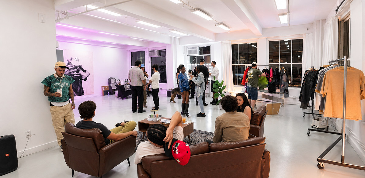 Guests mingling across the bright open loft floor during a creative studio gathering in NYC