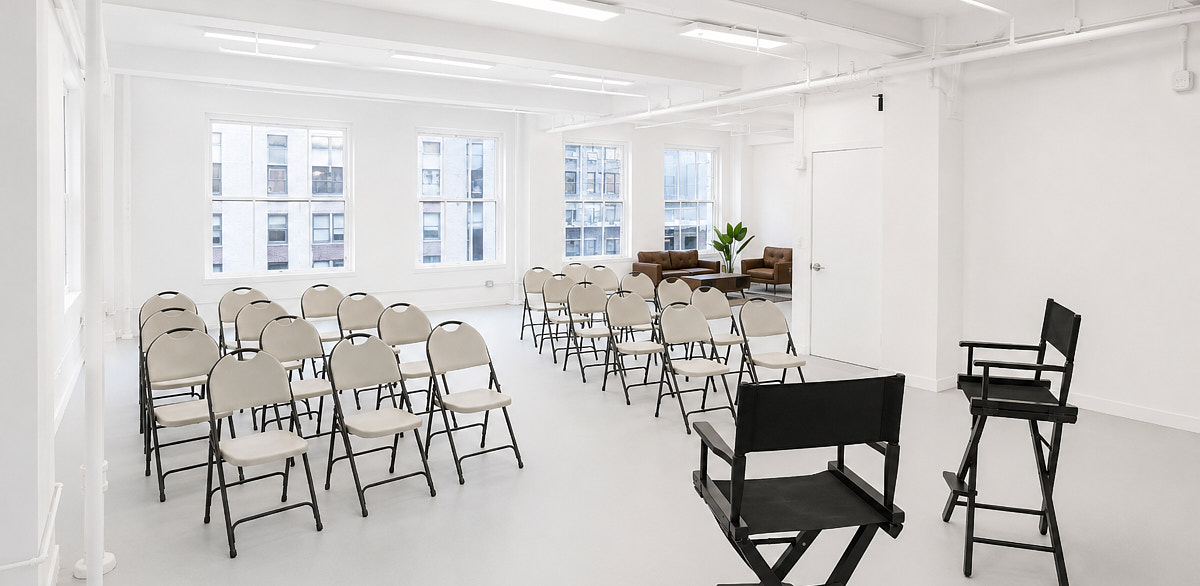 Workshop classroom layout at Match Studios NYC with rows of folding chairs, white walls, open studio floor, and a small presentation setup