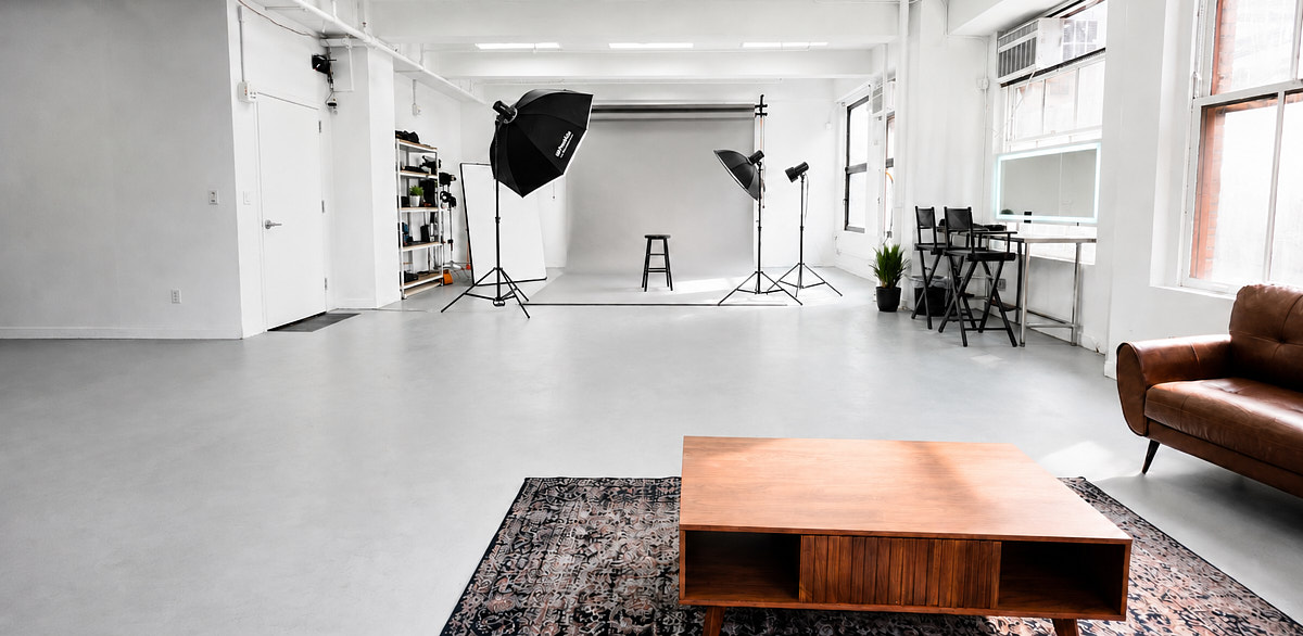 Portrait shooting setup in Match Studios NYC with open white floor, studio lights, window light, and flexible production space
